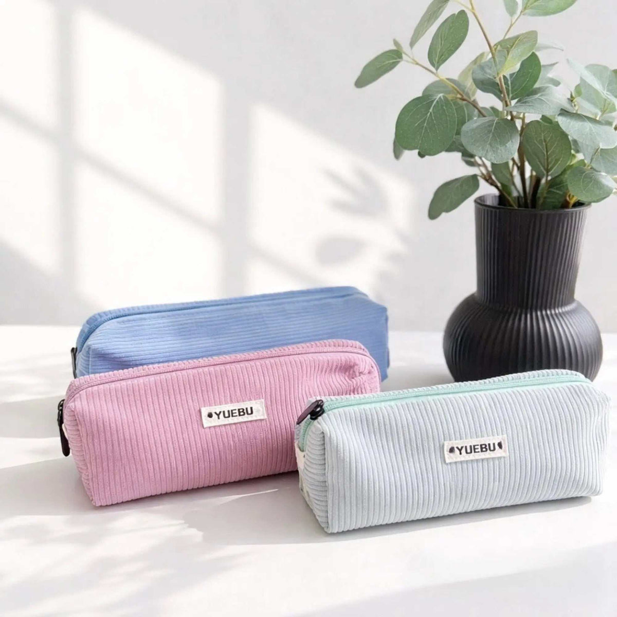 Stiftemäppchen Cord aus geripptem Stoff in Rosa, Hellblau und Mintgrün, mit Reißverschluss und kleinem Markenlabel.